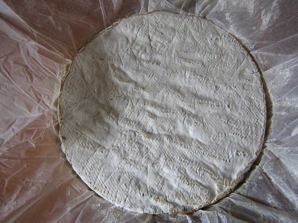 A wheel of Brie de Meaux cheese